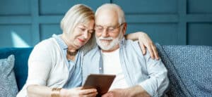 Happy couple researching hearing loss